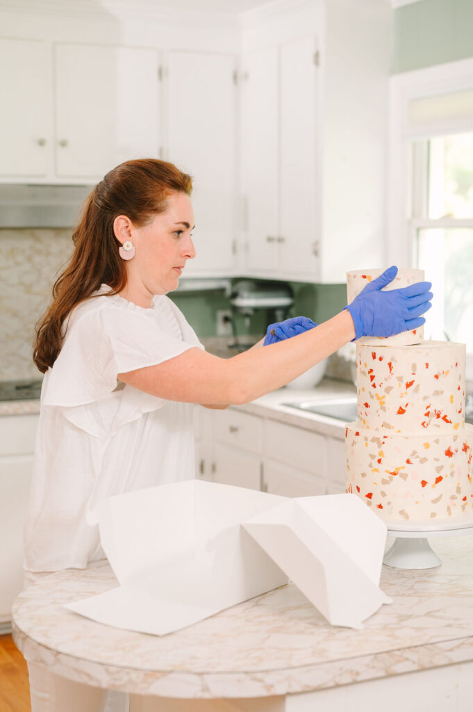 removing the top tier of a wedding cake